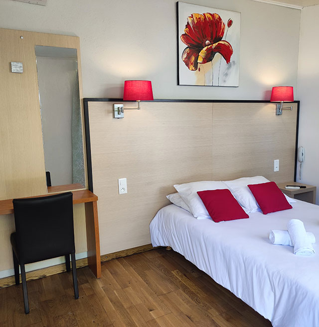 Comfortable PRM room with adapted bed for people with reduced mobility at the Relais du Val d'Orbieu